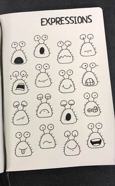 an open notebook with drawings of different expressions on the pages, including eyes and mouths