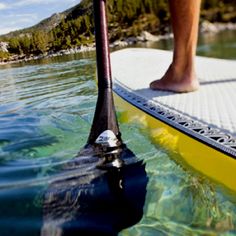 a person standing on a paddle board in the water