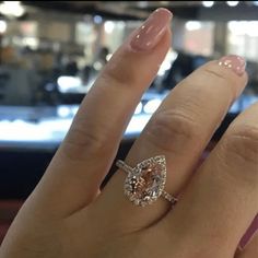 a woman's hand with a ring on it and a diamond in the middle