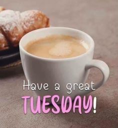 there is a cup of coffee and some pastries on the table with words have a great tuesday