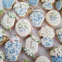 many decorated cookies are displayed on a table