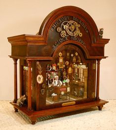 an old clock with many clocks on it's sides and the top shelf is made out of wood