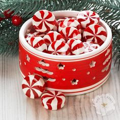 a red and white bowl filled with candy canes