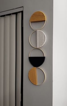 three circular artwork pieces hanging on the wall