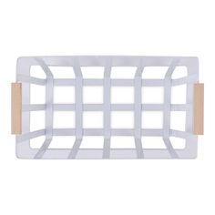 a white and wooden cutting board with squares on the front, one piece cut out to look like a grid