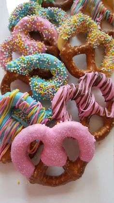 a bunch of doughnuts with sprinkles and frosting on them