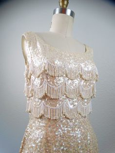 Glamorous Wedding Flapper Dress With Rhinestone Fringe, Glamorous Fringe Flapper Dress For Wedding, Sleeveless Sequined Flapper Dress For Wedding, Cream Embellished Sequin Fabric For Party, Cream Embroidered Sequin Fabric For Party, Cream Sequin Fabric For Party, Embellished Cream Sequin Fabric For Party, Vintage Sequin Dress For Wedding, 60s Bombshell