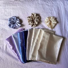 four different types of satin bows on a white sheet