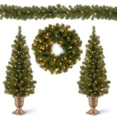 three christmas trees and a wreath with lights on them are shown in front of a white background