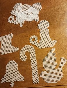 cut out pieces of paper sitting on top of a wooden table