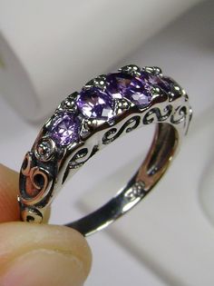 Purple Amethyst Cubic Zirconia Ring  Georgian Design#19 MADE TO ORDER Inspired by Georgian and Edwardian designs I now offer this stunning Antique reproduction in sterling silver. This gorgeous ring is set with flawless purple amethyst cubic zirconia gems (Natural Amethyst also available). The 5 stunning full cut purple CZs array the gorgeous setting which is 6mm NS on the finger; the gems are approximately 2ctw. The inside of the band is marked 925 for sterling silver. Notice the beautiful craf Georgian Ring, Victorian Filigree, Stock Design, Purple Amethyst Ring, Purple Rings, Amethyst Gem, Purple Band, Cz Ring, Victorian Jewelry