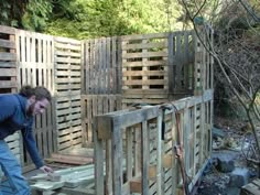 a man working on some wooden structures in the woods