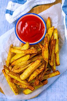 french fries with ketchup on the side and napkins next to each other