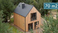 an aerial view of a small wooden house in the woods with a sign that reads 70 m2