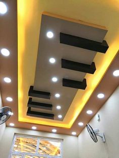 the ceiling in this room is decorated with lights and recessed lighting, along with an open window