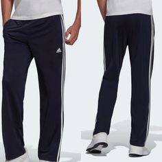 Adidas Primegreen Essentials Warm-Up Open Hem 3-Stripes Track Pants Blue New Rock A Sporty Look While Warming Up Or Relaxing. These Versatile Track Pants Have An Iconic 3-Stripes Look And An Open Hem. Cinch Down The Drawcord On The Elastic Waist For A Secure Fit When You're Hustling Across Town Or Playing Catch In The Park. This Product Is Made With Primegreen, A Series Of High-Performance Recycled Materials. Regular Fit Elastic Waist With Drawcord 100% Recycled Polyester Tricot Front Pockets Op Adidas Casual Pants With Three Stripes, Adidas Casual Bottoms With Three Stripes, Sporty Cotton Pants With Three Stripes, Casual Navy Pants With Three Stripes, Blue Athleisure Bottoms With Three Stripes, Adidas Jogging Bottoms With Three Stripes, Casual Straight Leg Pants With Three Stripes, Athleisure Full Length Bottoms With Three Stripes, Casual Full Length Bottoms With Three Stripes