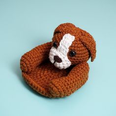 a crocheted stuffed animal is sitting on a blue surface