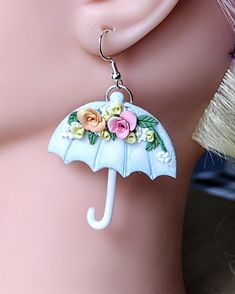 Introducing our stunning Umbrella Earrings, the perfect whimsical gift for her! These handmade earrings are an ideal gift for your wife or even for back to school teacher appreciation. With delicate floral details, these unique earrings add a touch of elegance to any outfit. Whether it's a unique birthday gift or just a little something to brighten her day, these beautiful earrings are sure to be cherished. Shop now for this one-of-a-kind piece of weather jewelry that will surely make her heart skip a beat.   These spring earrings are lovingly handcrafted with a unique design, making them a great addition to any  jewelry collection. They'll be sure to be noticed and make any outfit pop. Give these cute dangle earrings as a thoughtful present to a special teacher to show your appreciation. Whimsical Polymer Clay Earrings For Gift, Whimsical Polymer Clay Earrings As Gift, Adjustable Whimsical Drop Earrings, Whimsical Adjustable Drop Earrings, Charming Earrings For Pierced Ears As Gift, Charming Earrings As A Gift, Whimsical Everyday Drop Earrings Jewelry, Whimsical Everyday Drop Earrings, Everyday Whimsical Drop Earrings