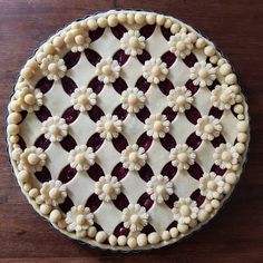 a pie with white and red decorations on it