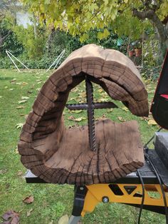 a large piece of wood sitting on top of a table next to a tree stump