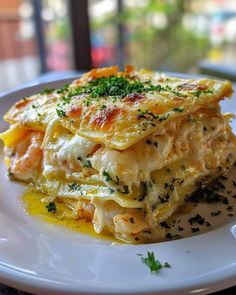 a white plate topped with lasagna covered in cheese