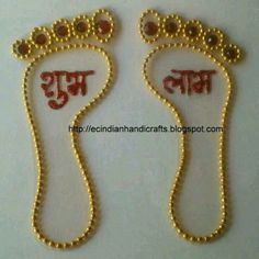 pair of feet in gold with red stones on the toes and foot beads attached to them