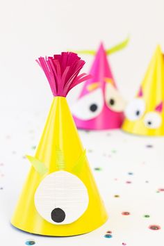 three party hats with different colored decorations on them