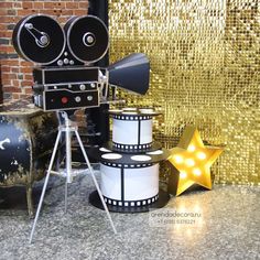 an old fashioned movie projector sitting on top of a table next to a star