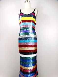 "Such a colorful dress! It's fully embellished with bright sequins in a horizontal stripe design. There are a few blue sequins missing on the back. Otherwise, it's in excellent condition! Measurements: Bust - 32/34\" Waist - 24/26\" Hips - 34/36\" Length - 62\" Tag Size - Small This dress comes from a pet-free and smoke-free home. If you would like more info or have any questions, please don't hesitate to ask!" Multicolor Maxi Dress For Evening Parties, Multicolor Sequined Maxi Dress For Party, Multicolor Sequin Carnival Dress, Striped Fitted Maxi Dress For Party, Fitted Striped Maxi Dress For Party, Glamorous Multicolor Party Maxi Dress, Multicolor Sequined Maxi Dress, Embellished Multicolor Maxi Dress For Party, Multicolor Sequined Maxi Dress For Summer