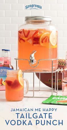 there is a large glass jar filled with liquid and lemons next to other drinks