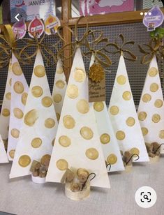 several paper trees with gold polka dots on them