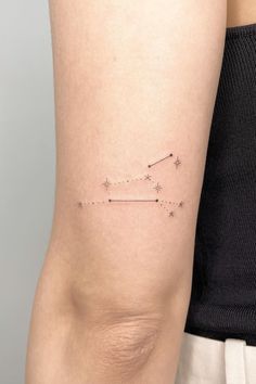 a woman's arm with a small star tattoo on the left side of her arm