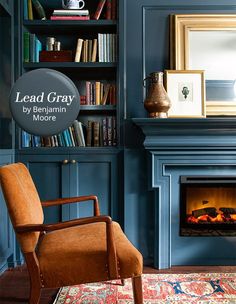 a chair sitting in front of a fireplace with bookshelves behind it and a sign that reads lead gray by person more