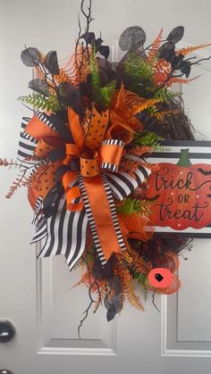 a halloween wreath hanging on the front door