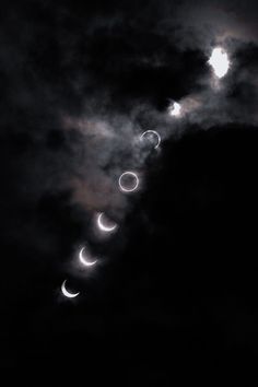 the moon is lit up in the dark sky as it passes through the cloudy clouds