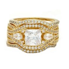 a gold ring with white stones and diamonds on the sides, set against a white background