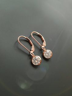 "These 14k yellow gold filled earrings are small, simple and are great for every day wear! A crystal clear 6mm round CZ hangs from 14k Gold Filled leverback or french earwires. The total length of these earrings is almost 1\". Available in yellow and rose gold Find more rose and yellow gold earrings here: https://www.etsy.com/shop/IDreamofJewelry?ref=hdr_shop_menu&search_query=gold+earrings Please let me know if you have any questions!" Quartz Crystal Jewelry, Small Drop Earrings, Earrings Round, Silver Bow, Silver Jewelry Fashion, Gold Filled Earrings, Swarovski Crystal Earrings, Cz Earrings, French Wire