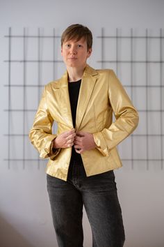 Buy 3 items and get 30% off your entire order. Limited offer. All orders are shipped via FedEx. Shipping to the US typically takes 2 to 3 business days, while within the EU, it takes 2 to 6 business days. A true statement piece! This vintage nappa leather blazer comes in a striking bold golden hue, making it a standout addition to any wardrobe. The single-breasted, fitted design exudes sophistication and is tailored to perfection. Key details include a single-button closure, notch lapels, and st Chic Gold Blazer For Business, Gold Blazer For Workwear In Spring, Luxury Gold Blazer For Spring, Gold Luxury Blazer For Spring, Classic Gold Outerwear For Evening, Gold Business Outerwear For Fall, Gold Outerwear For Business In Fall, Gold Blazer For Spring Workwear, Classic Gold Evening Blazer