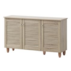 a wooden cabinet with shutter doors on the front and two legs, against a white background