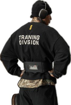 a man wearing a black shirt with the words training division on it's back