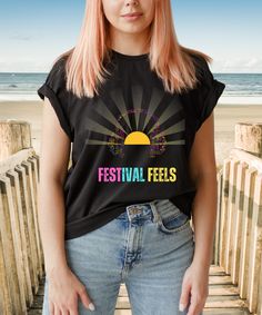 Feel the vibrant energy of summer festivals with our "Festival Feels" tee, where the sun itself grooves to the beat, adorned with colourful headphones. This shirt captures the electrifying atmosphere of music, laughter, and camaraderie that defines festival season. Whether you're dancing in the sunshine or soaking in the sounds of your favourite artists, wear it as a badge of your love for music and celebration. Let the festival vibes flow and embrace the spirit of summer in style. - 100% cotton Heavyweight Unisex Crewneck T-shirt Gildan 5000   Size guide                             SMLXL2XL3XL4XL5XL A) Length (cm)71.173.776.278.781.383.88689 B) Half Chest (cm)45.750.855.9616671.17681                             SMLXL2XL3XL 4XL   5XL A) Length (cm)71.173.776.278.781.383.88689 B) Half Chest Casual Cheap T-shirt For Music Festival, Cheap Graphic Print T-shirt For Festivals, Cheap Casual T-shirt For Music Festival, Cheap T-shirt With Letter Print For Music Festival, Affordable Festival T-shirt With Screen Print, Cheap Trendy T-shirt For Music Festivals, Cheap T-shirt For Music Festivals, Cheap Women's T-shirt For Music Festivals, Affordable Cotton Shirt For Music Festival