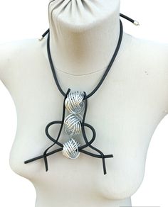 Rubber Statement Necklace Black Rubber Cord Silver Pendant Necklace Avant-garde Woman's Jewelry Funky Rubber Necklace The combination of rubber and aluminum is a new world fashion trend.  This abstract design will surely set you apart from others.  Tangled orbs of aluminum wire in contrast to the black rubber tube.  Give yourself or a loved one something completely different  Out of trends and trends of the moment  FAR FROM ORDINARY  MATERIALS:  - rubber cord  - rubber band - aluminum wire 2mm Modern Metal Collar Necklace, Sculptural Jewelry Inspire Uplift ⭐, Modernist Necklace With Large Pendant As Gift, Large Pendant Necklace, Wearable Art Gift, Avant Garde Necklace, Asymmetrical Jewelry, Rubber Necklace, Black Necklace Statement, Abstract Necklace