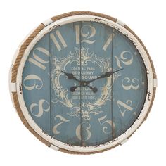 a blue and white wall clock with numbers on it's face, hanging from a rope