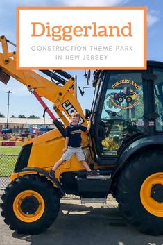 a young boy standing on the back of a construction vehicle in front of a sign that says diggerland