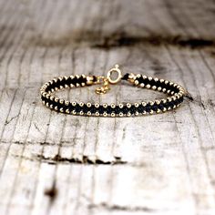 This bracelet uses the same technique as the old friendship bracelets we've all come to know and love, but with a bit of a twist.  14K Gold Filled beads and clasp hand knotted using natural jewelry linen thread. The bracelet is adjustable 15.5cm to 18.5cm long. (6.1-7.3Inches) Gold Filled is by no means gold plated. It is a much thicker layer of gold that is welded to the bottom brass layer and therefore lasts much longer (can last a life time, depending on wear).  Can be gift wrapped just let m Everyday Gold Beaded Braided Bracelets, Gold Beaded Bangle Friendship Bracelet, Friendship Bangle Jewelry With Tiny Beads, Friendship Bangle With Tiny Beads, Hand-strung Round Friendship Bracelets, Hand-strung Friendship Bracelet Jewelry, Hand-strung Friendship Bracelet, Gold Hand-strung Braided Bracelets, Gold Hand-strung Friendship Bracelets As Gift