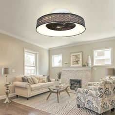 a living room filled with furniture and a fire place in the middle of the room