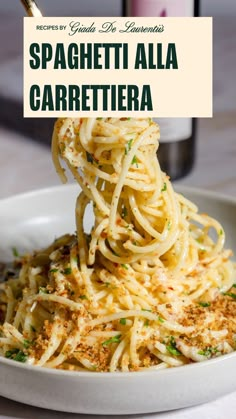 A grey bowl filled with spaghetti topped with grated parmesan cheese, chopped basil and toasted breadcrumbs. there is a bottle of garlic infused olive oil in the background for styling purposes. Spaghetti Alla Carrettiera, Garlic Infused Oil, Giada De Laurentiis Recipes, Resep Pasta, Aglio E Olio, Raw Garlic, Infused Oil, Sicilian Recipes