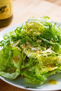 a white plate topped with lettuce and other vegetables