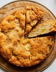 a pie on a wooden plate with slices cut out