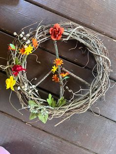 a wreath made out of branches with flowers